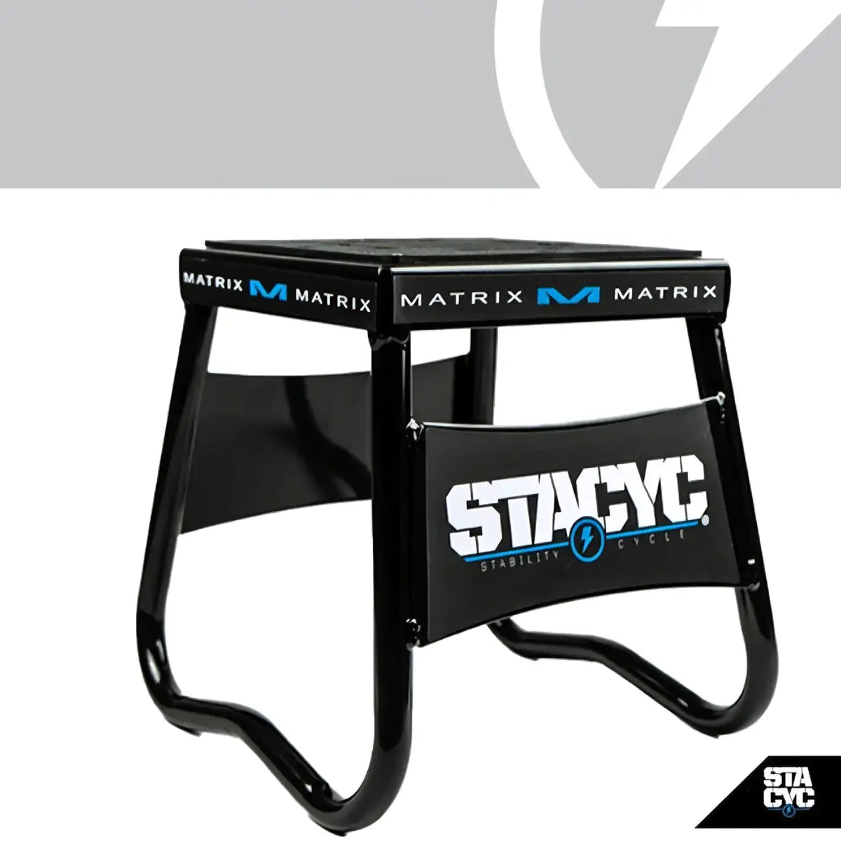 Black metal stacyc bike support stand with matrix m branding and stacyc stability cycle logo on the front panel