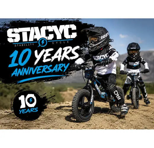Black and blue stacyc stability cycle electric balance bike with rugged tires and protective gear for kids riding