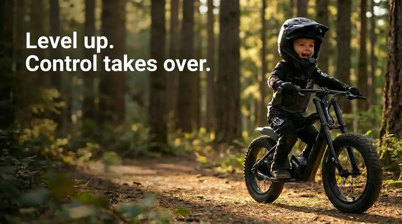 Black helmeted child riding a black electric bike through a forest trail.
