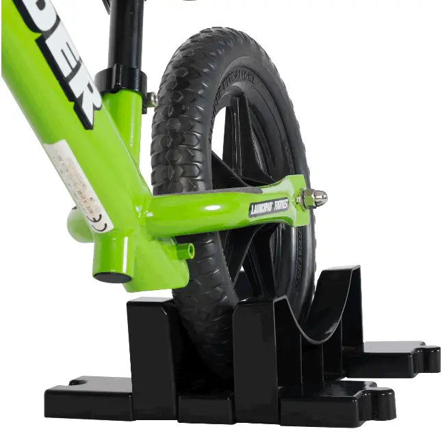 Bright green children’s balance bike with black tires and sturdy frame branded lanikai forest shown from the back side